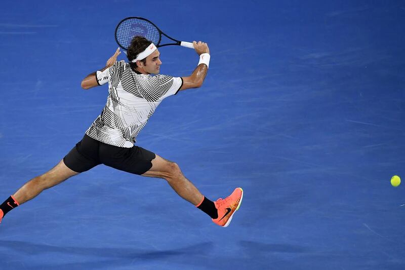 Roger Federer returns a backhand during the Australian Open final. Andy Brownbill / AP Photo