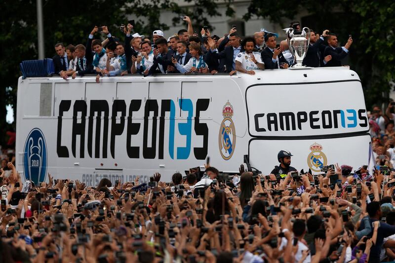 Real Madrid players wave to fans from the top of an open top bus in Cibeles square, in Madrid, Spain, Sunday, May 27, 2018. Francisco Seco / AP Photo