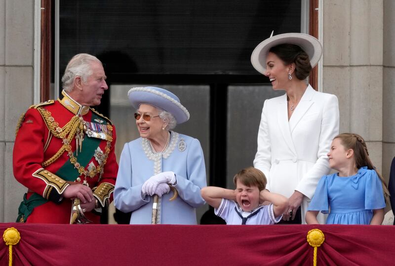 Prince Charles, left, with the queen, Prince Louis her grandson, covering his ears with his hands, next to Kate and Princess Charlotte, on the balcony of Buckingham Palace. AP