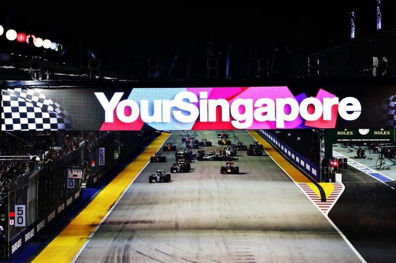 Nico Rosberg of Mercedes leads Daniel Ricciardo of Red Bull and Lewis Hamilton of Mercedes at the start of the Formula One Singapore Grand Prix. Lars Baron / Getty Images