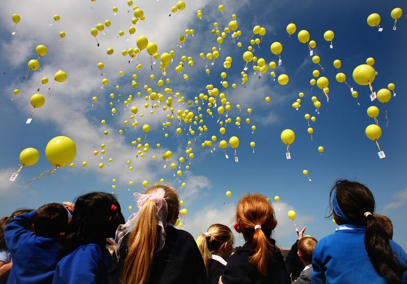 Pupils at Bankhead Primary School release yellow balloons for Madeleine McCann in June 2007 in Glasgow, Scotland. About 400 were released, each with a tag attached containing appeal information.