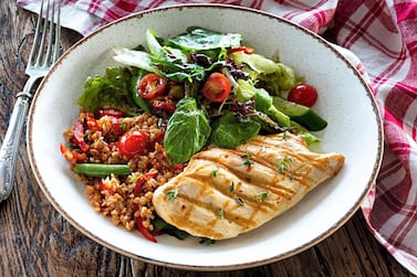 Chicken breast with bulgur tabbouleh and green salad. Getty 