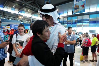 DUBAI , UNITED ARAB EMIRATES , March 20 – 2019 :- Omer Alshami from UAE with his father Sharif Alshami after the victory ceremony of the 4x50m freestyle relay at the Special Olympic games held at Hamdan Sports Complex in Dubai. ( Pawan Singh / The National ) For News/Instagram/Online/Big Picture . Story by Ramola