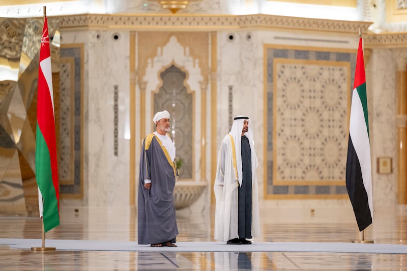 President Sheikh Mohamed and Sultan Haitham stand for the national anthems during a state visit reception at Qasr Al Watan in Abu Dhabi