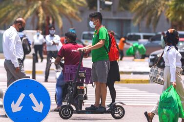 Pedestrians wear face masks in Abu Dhabi. Victor Besa/The National