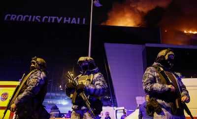 Russian law enforcement officers stand guard near the Crocus City Hall concert venue. Reuters