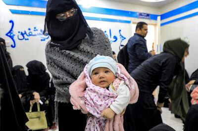 A woman carries a child at a medical centre in Yemen's rebel-held capital Sanaa. AFP