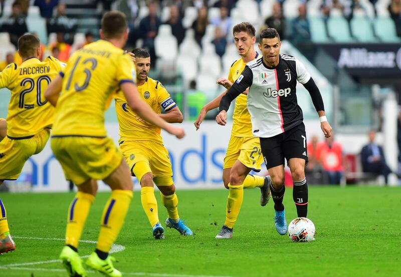 Juventus' Cristiano Ronaldo in action with Hellas Verona's Marash Kumbulla and Miguel Veloso. Reuters