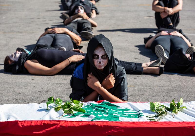 epa08483623 Lebanese anti-government protesters with black dresses perform a symbolic funeral for the Lebanese citizens and their country during protests in downtown Beirut, Lebanon, 13 June 2020. Anti-government protesters continue gathering as they block the roads during a protest against the economic condition, the collapsing Lebanese pound currency, and increasing prices.  EPA/NABIL MOUNZER