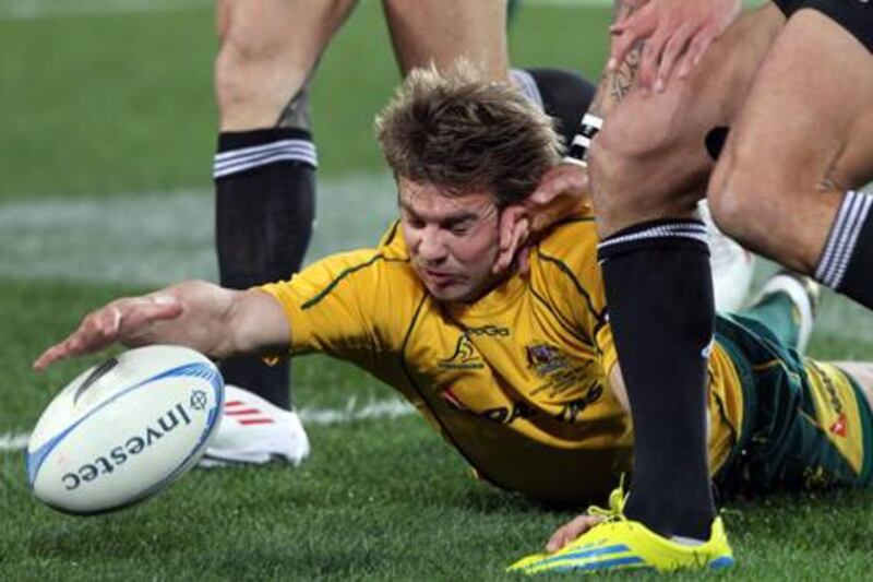 Australia's Drew Mitchell dives for the ball against New Zealand in the Rugby Championship clash in Auckland