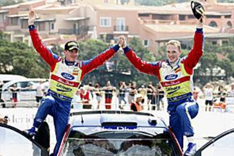 Jari Matti Latvala, right, and his co-pilot Miikka Anttila celebrate winning the Rally d'Italia in Sardinia.