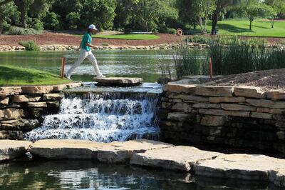 DUBAI, UNITED ARAB EMIRATES - NOVEMBER 13:  Tommy Fleetwood of England walks over a water feature or waterfall during the DP World Tour Championship ProAm held at Jumeirah Golf Estates on November 13, 2018 in Dubai, United Arab Emirates.  (Photo by Andrew Redington/Getty Images)