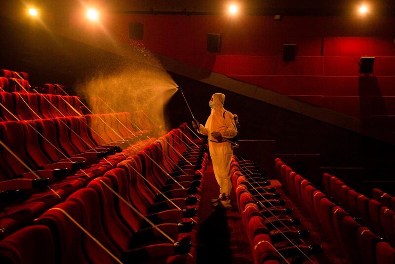 A worker disinfects a movie theatre before its reopening to the public in the southern Iraqi city of Basra  following an easing of restrictions imposed by the authorities in a bid to stem the spread of the novel coronavirus.   AFP