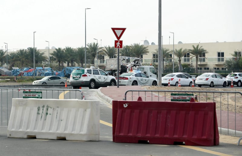 DUBAI, UNITED ARAB EMIRATES , April 18– 2020 :- Dubai Police checking vehicle entering from Manama street to International City in Dubai. Only two entrance are open for vehicles coming from Al Awir road before the Dragon Mart 1 and Manama Street to International City in Dubai.  Dubai is conducting 24 hours sterilisation programme across all areas and communities in the Emirate and told residents to stay at home. UAE government told residents to wear face mask and gloves all the times outside the home whether they are showing symptoms of Covid-19 or not.  (Pawan Singh / The National) For News/Online