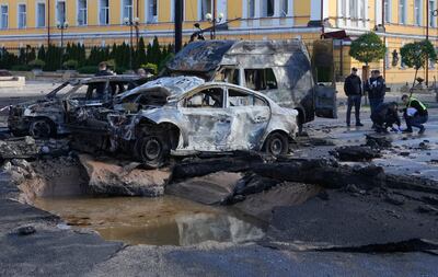 Damaged cars are seen at the scene of shelling in Kyiv. AP