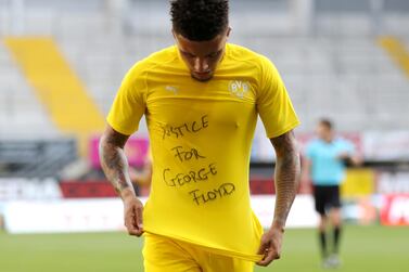 Soccer Football - Bundesliga - SC Paderborn v Borussia Dortmund - Benteler Arena, Paderborn, Germany - May 31, 2020 Borussia Dortmund's Jadon Sancho celebrates scoring their second goal with a 'Justice for George Floyd' shirt, as play resumes behind closed doors following the outbreak of the coronavirus disease (COVID-19) Lars Baron/Pool via REUTERS DFL regulations prohibit any use of photographs as image sequences and/or quasi-video TPX IMAGES OF THE DAY