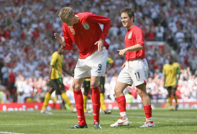 England's Peter Crouch, centre, celebrates scoring against Jamaica during their international friendly soccer match at Old Trafford Stadium, Manchester, England, Saturday June 3, 2006. (AP Photo/Dave Thompson)