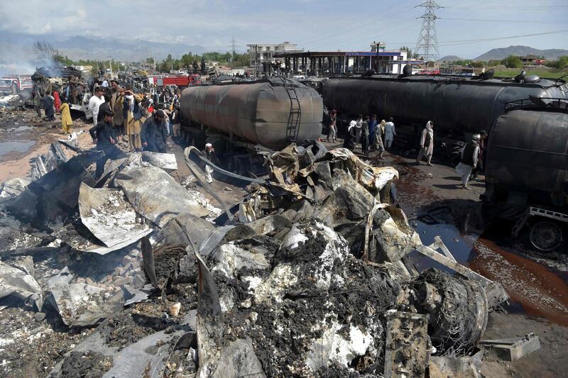 Local residents and owners of fuel tankers inspect the debris following an overnight ablaze in which several fuel tankers caught fire at Qala-e-Murad Bek area on the outskirts of Kabul. AFP
