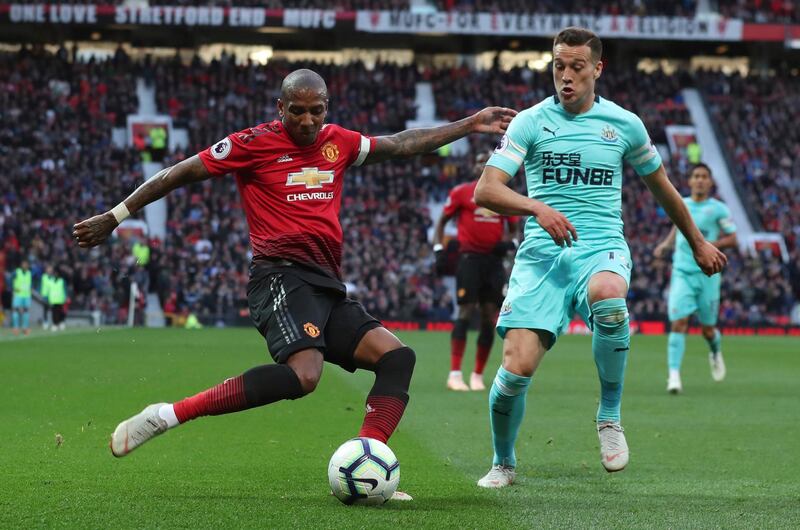 Manchester United's Ashley Young, left attempts to cross the ball as Newcastle United's Javier Manquillo challenges. AP Photo