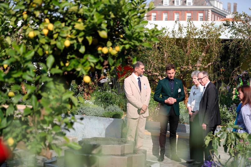 Britain's prime minister Theresa May and her husband Philip  are shown around the Lemon Tree Trust Garden.