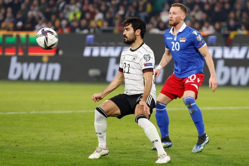 Germany midfielder Ilkay Gundogan and Liechtenstein's defender Sandro Wolfinger vie for the ball. AFP