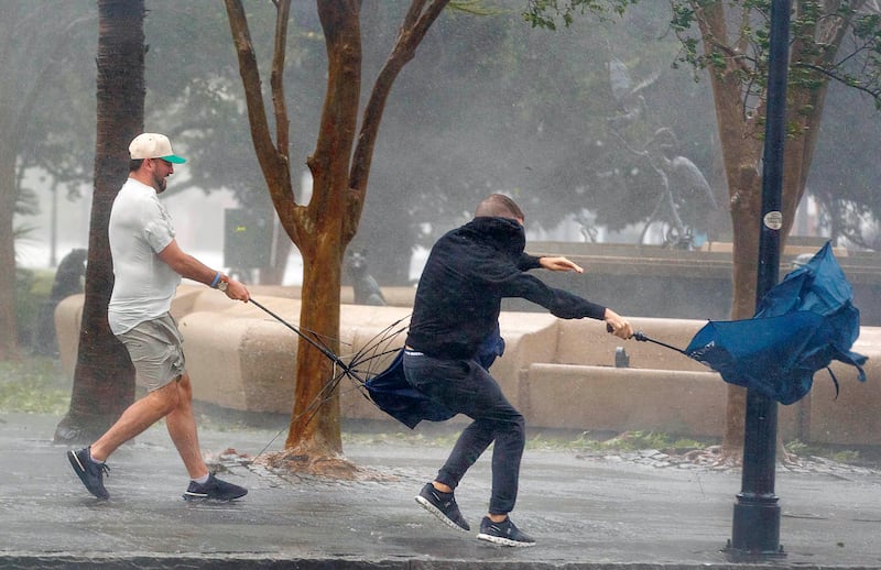 Wind gusts, blowing down King Street, twist umbrellas during Hurricane Ian in Charleston, South Carolina. AP