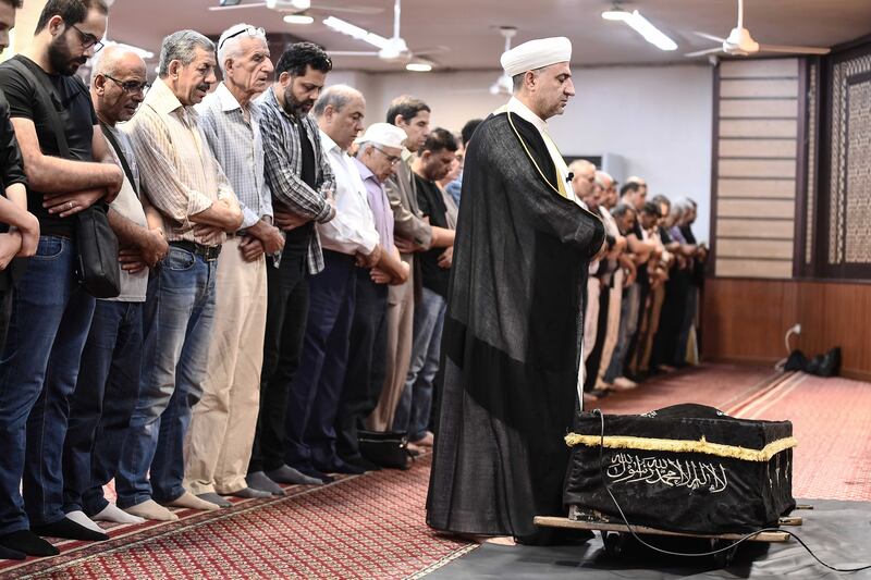 Mourners at the Lala Basha mosque perform prayers over Mr Khalifa's coffin
