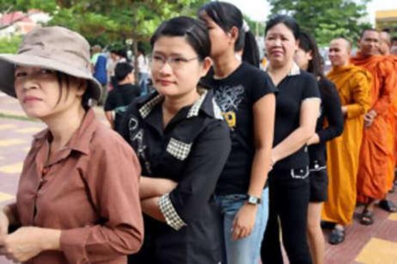 Voters queue up at a polling station in Phnom Penh today. Polls opened in Cambodia for legislative elections widely expected to extend prime minister Hun Sen's 23-year grip on power.