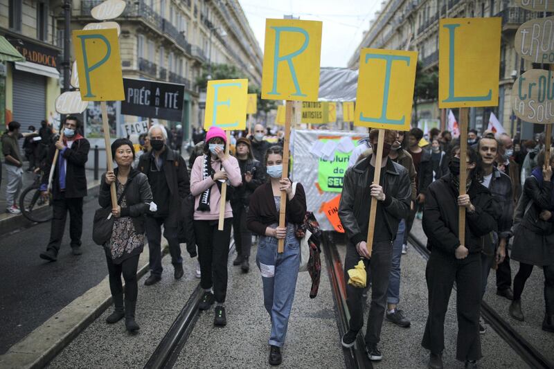 Workers demonstrate with placards reading "Peril" on May Day in Marseille, southern France, Saturday, May 1, 2021. (AP Photo/Daniel Cole)