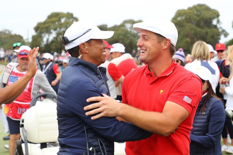 Woods  and Bryson DeChambeau enjoy the win in Melbourne. Getty