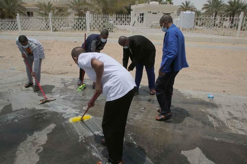 These five men were fined and made to sweep the streets for reckless driving.