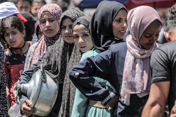 A queue for food rations at a public kitchen in Deir El Balah. AFP