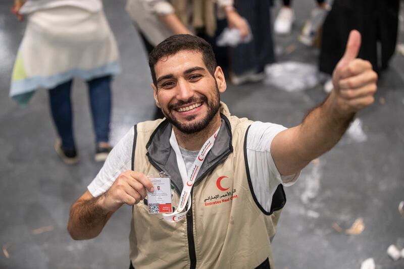 Volunteers pack food, blankets and other essential goods at the Dubai Exhibition Centre, at Expo City