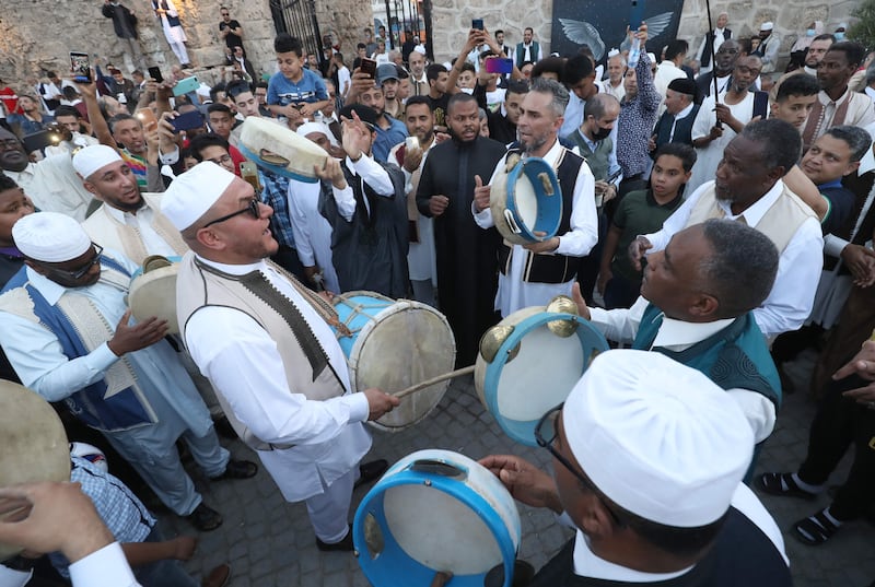 Libyans gather around a troupe at the Bab al-Jadid gate in the old city of the capital Tripoli, as they celebrate the third day of Eid al-Fitr, which marks the end of the holy fasting month of Ramadan. AFP