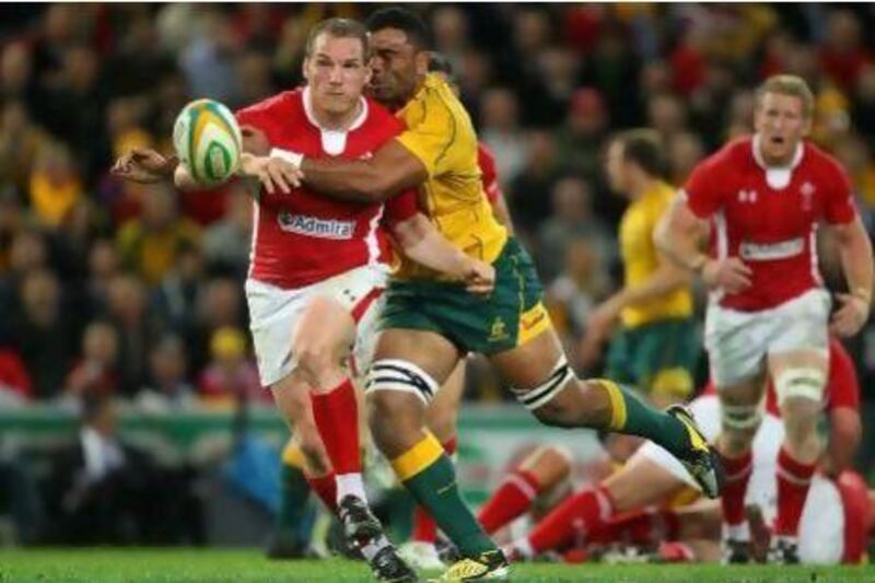 Gethin Jenkins of Wales is tackled by Wycliff Palu of the Wallabies.