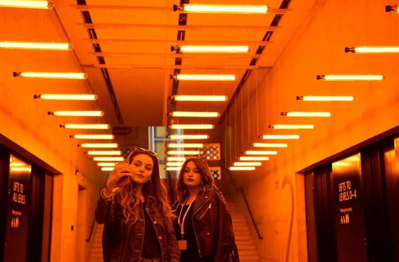 Women view Danish-Icelandic artist Olafur Eliasson's work 'A Room for One Colour' at the Tate Modern in London. Photo: EPA