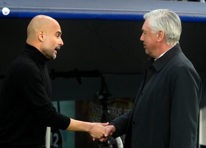 Manchester City coach Pep Guardiola shakes hands with Real's   Carlo Ancelotti. AP