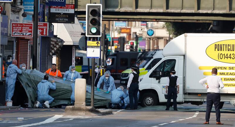 FILE - In this file photo dated Monday, June 19, 2017, forensic officers move the van which struck pedestrians near a Mosque at Finsbury Park in north London.  A Crown Court on Thursday Feb. 1, 2018, found Darren Osborne guilty of murder and attempted murder in the June 2017 attack in the city's Finsbury Park neighborhood. (AP Photo/Frank Augstein, FILE)