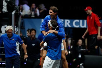 Europe's Roger Federer celebrates with teammate Rafael Nadal, top center, after defeating World's Nick Kyrgios during their Laver Cup tennis match in Prague, Czech Republic, Sunday, Sept. 24, 2017. (AP Photo/Petr David Josek)