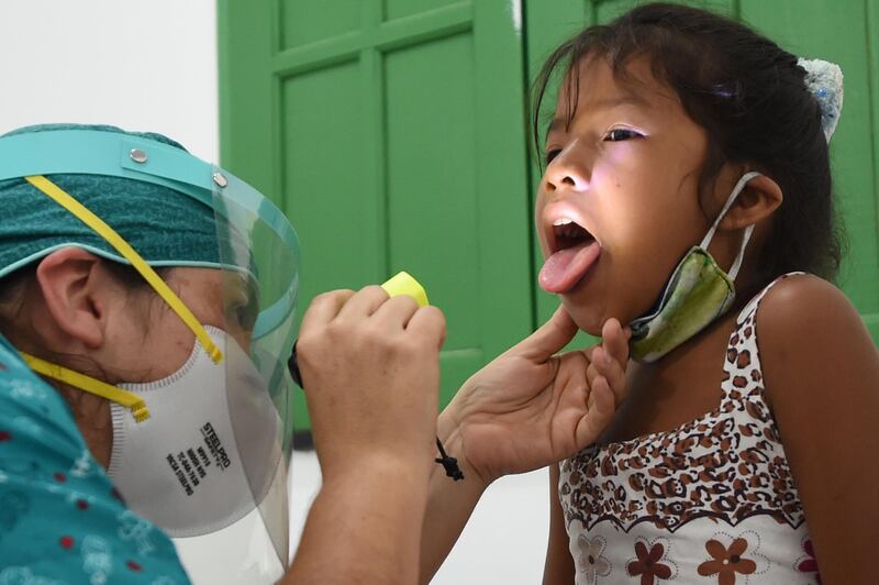 An indigenous girl of the Ticuna ethnic group receives medical assistance at a health post in the Umariacu village, Tabatinga, Amazonas state, Brazil. AFP