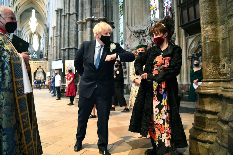 UK Prime Minister Boris Johnson elbow bumps with actress Helena Bonham Carter, during a service at Westminster Abbey, London, to commemorate the life of nurse Florence Nightingale and to mark the contribution of nurses to the community. AP Photo