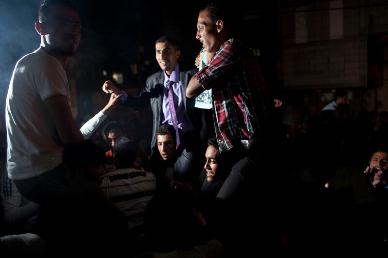 Shadi Assaf (middle) the brother of Mohammed Assaf react with joy  with other family members and friends outside  the family home in a refugee camp  Khan Younis, Gaza , as  Mohammed Assaf is announced the winner of the  regional 'Arab Idol' singing contest held in Beirut , Lebanon June 22,2013.Thousands of Palestinians in Gaza and the West Bank took to the streets to celebrate his victory. (Photo by Heidi Levine/Sipa Press). *** Local Caption ***  IMG_0555.jpg