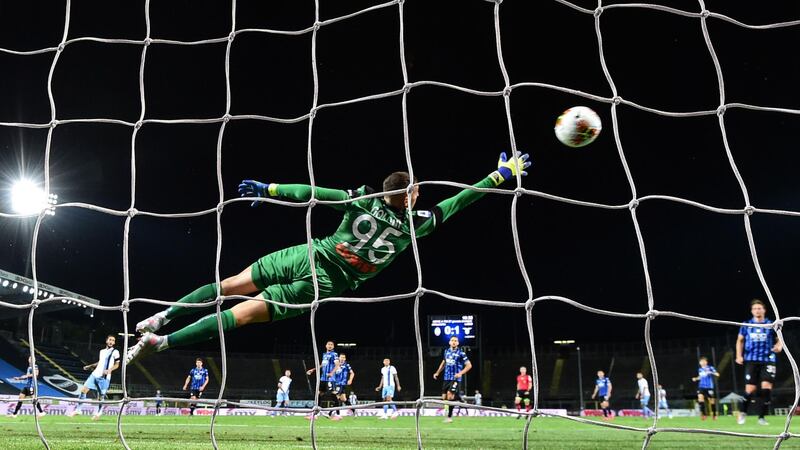 Atalanta's Italian goalkeeper Pierluigi Gollini concedes the second goal from Lazio's Serbian midfielder Sergej Milinkovic-Savic  during their Serie A football match at the Atleti Azzurri d'Italia stadium in Bergamo. AFP