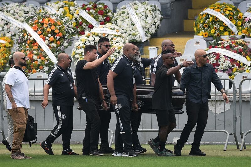 Pallbearers carry the casket of Brazilian football legend Pele into the Urbano Caldeira Stadium in Santos. Brazilians bid a final farewell to Pele this week, starting with a 24-hour public wake on Monday, January 2, 2022. AFP