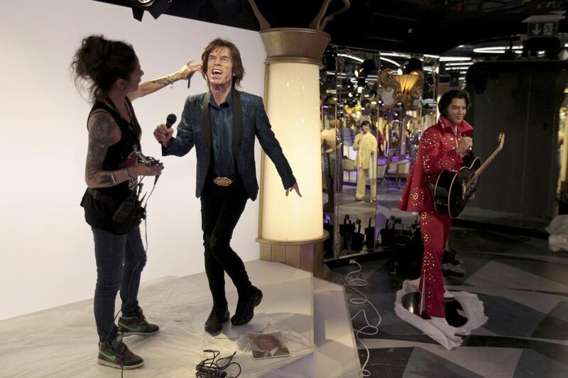 Hairdresser Virginie Dahan puts the final touches to Rolling Stones lead singer Mick Jagger’s statue. David W Cerny / Reuters 