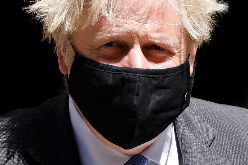 Britain's Prime Minister Boris Johnson, wearing a face mask, leaves 10 Downing Street in central London. AFP