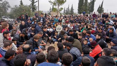 Mourners attend the funeral of Raed Fares and Hammoud al-Jneid in the village of Kafranbel in the northwestern province of Idlib on November 23, 2018. / AFP / Muhammad HAJ KADOUR
