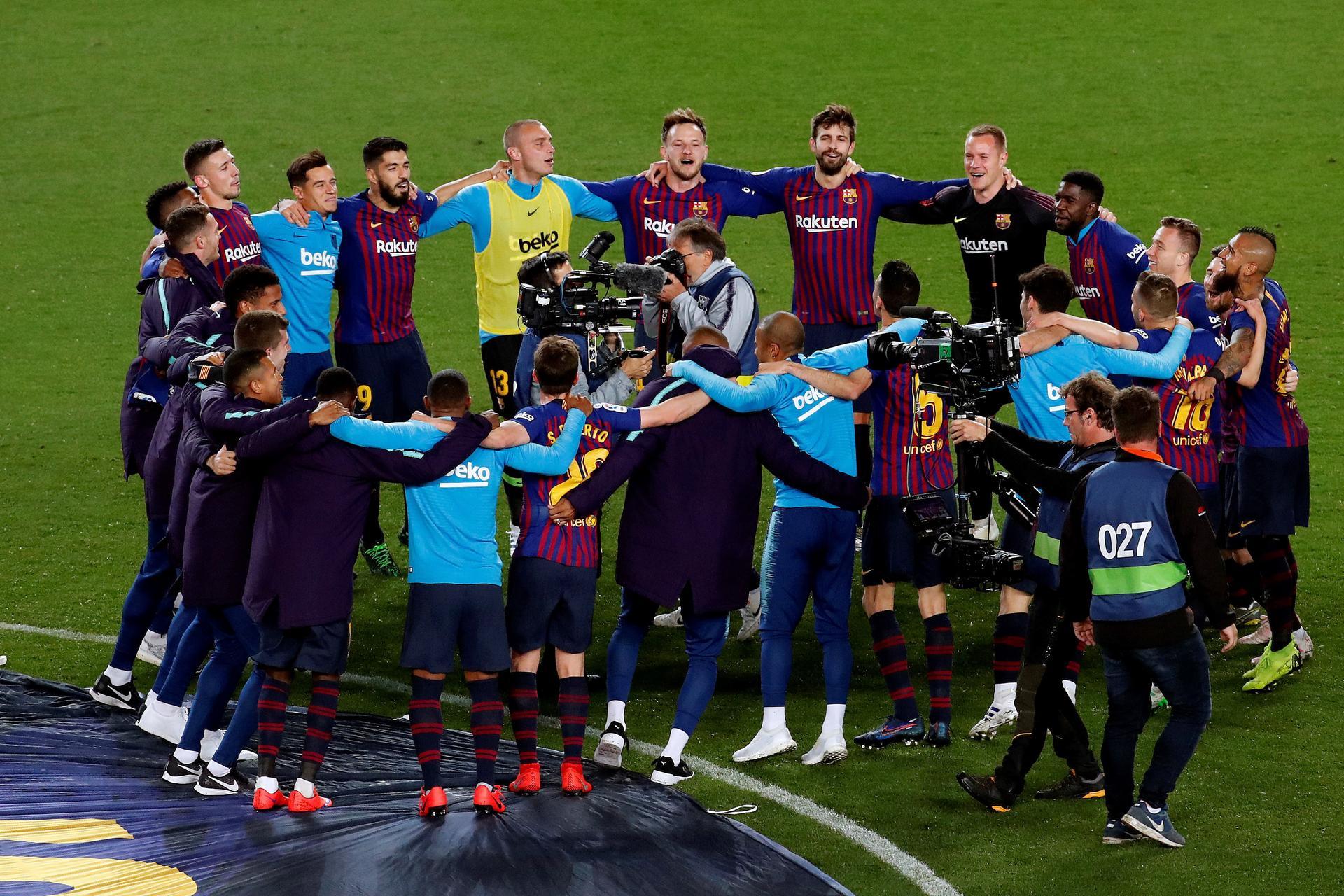 Barcelona's players form a circle in celebration at the final whistle. EPA