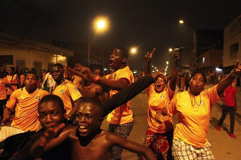 Supporters of Ivory Coast celebrate in the streets of Abidjan on Sunday after their team beat Ghana in the Africa Cup of Nations final. Legnan Koula / EPA