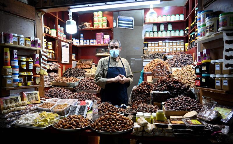 A date vendor stands among his wares at Kuwait City's Souk Al Mubarakiya.  EPA